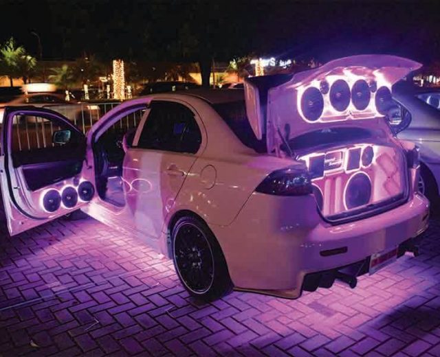 modified car with neon lights and speakers